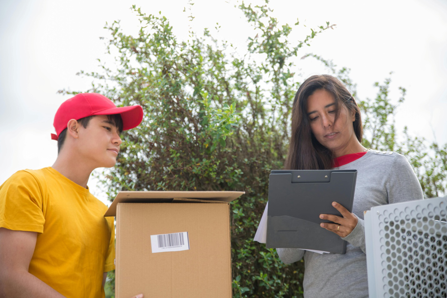 A picture of people checking barcode of a delivery box