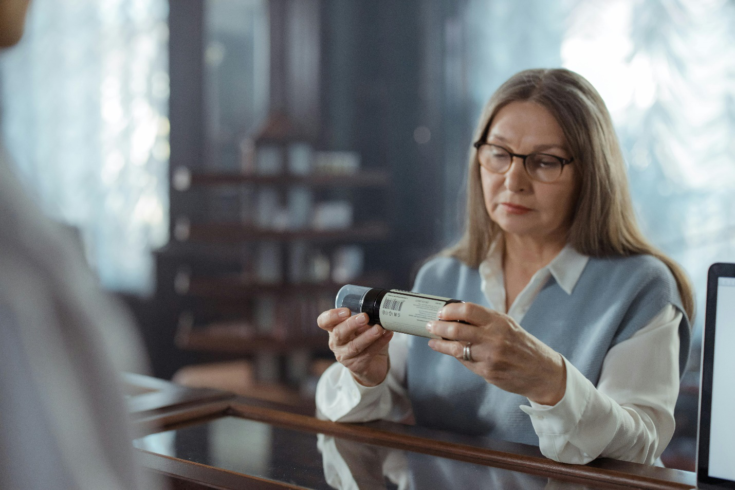 A picture of a person looking at a pharmaceutical product 