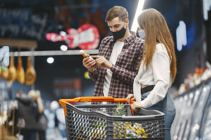 Two people looking at a product label