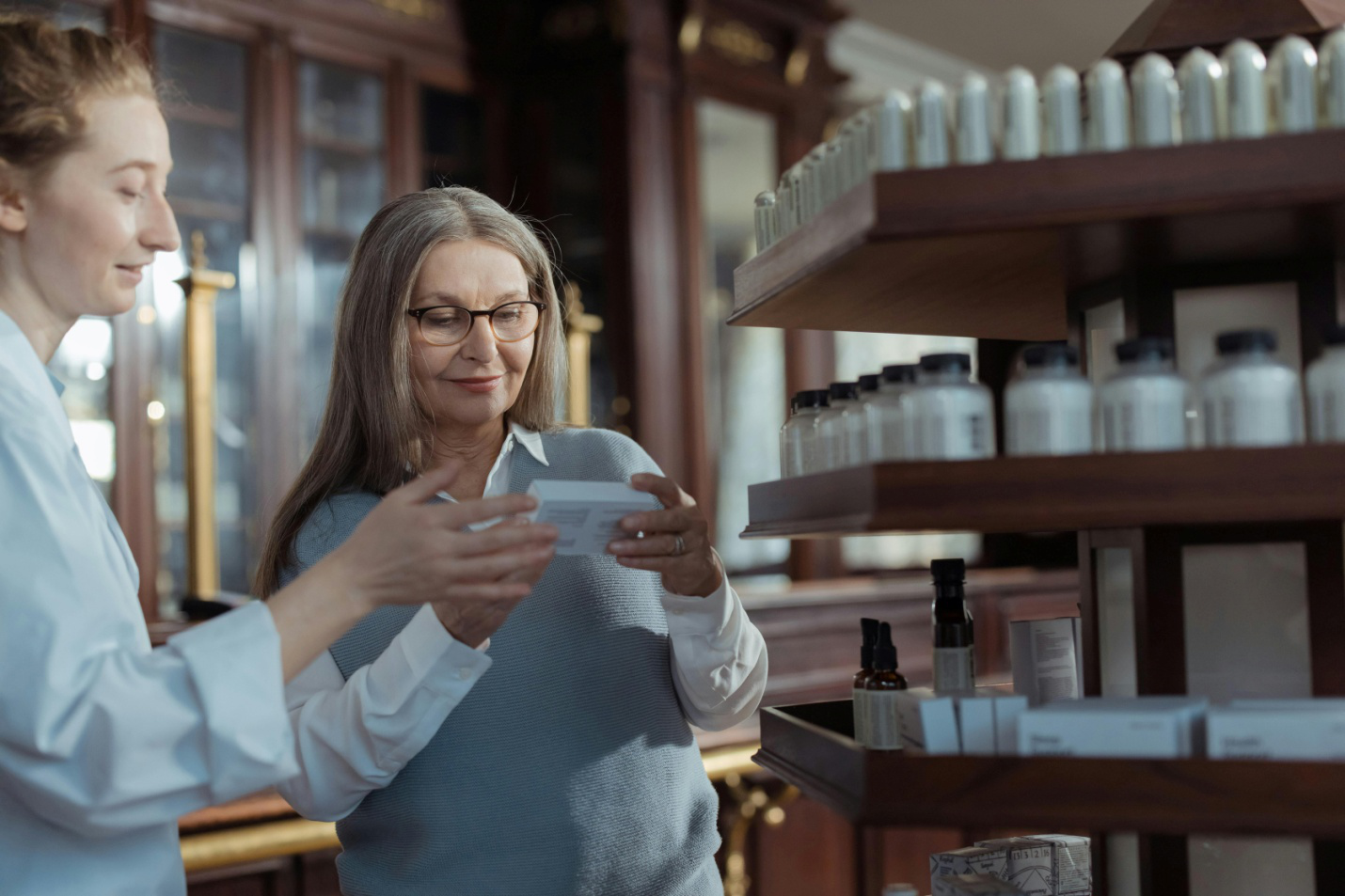 A picture of a pharmacist showing a product to a customer